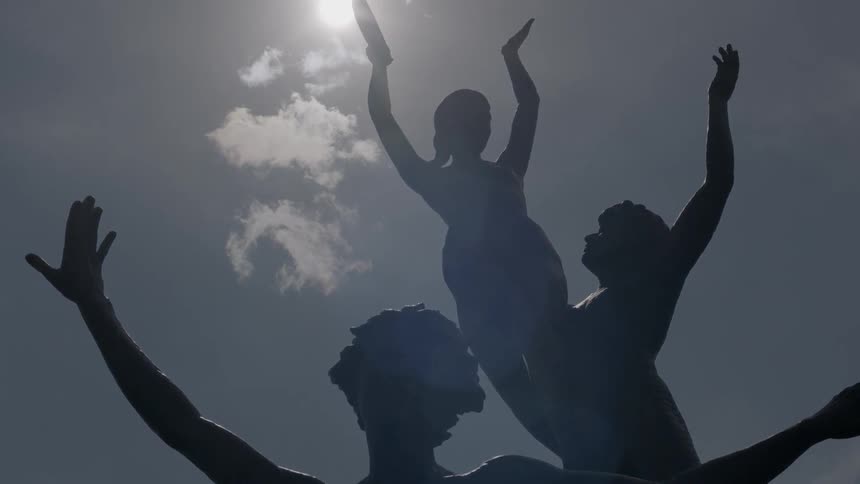 A statue of women on a sunny day
