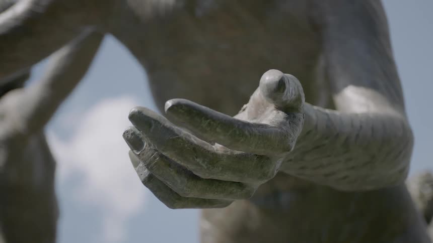 A statue on a partly cloudy day