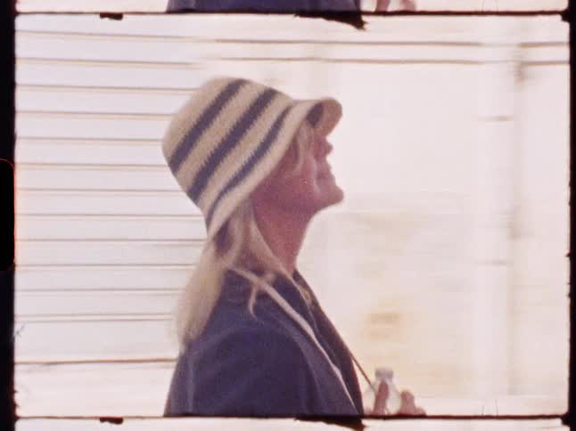 The woman walks by the building