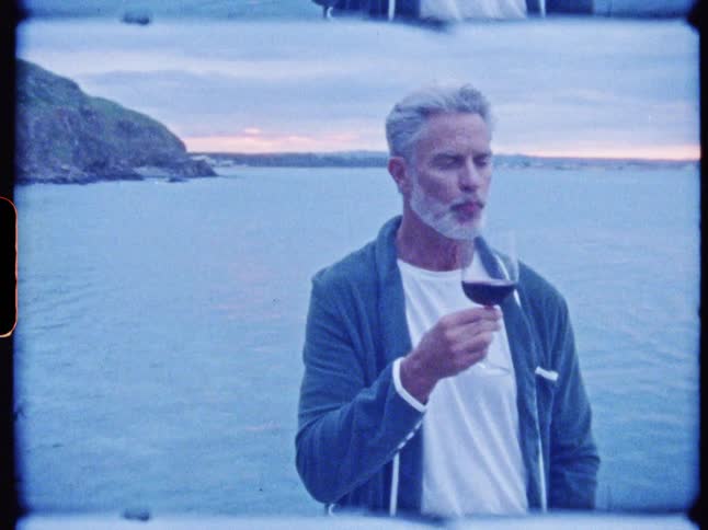 Man at the seaside enjoying a glass of red wine