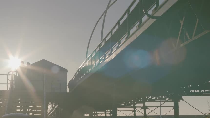 A person is walking along the boardwalk above