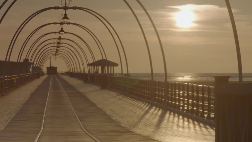 A long pier goes out into the water