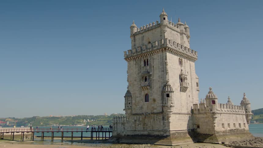 A stained white building near a body of water