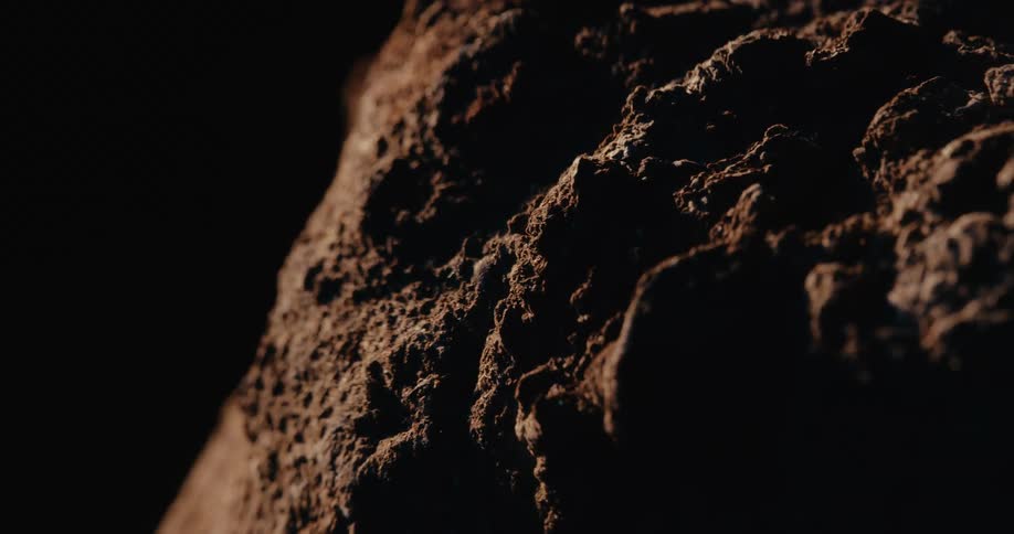 Weathered rock against a black background