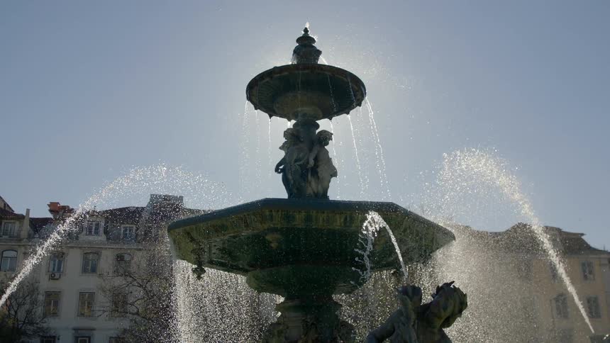 Water flows and sprays in a tiered fountain