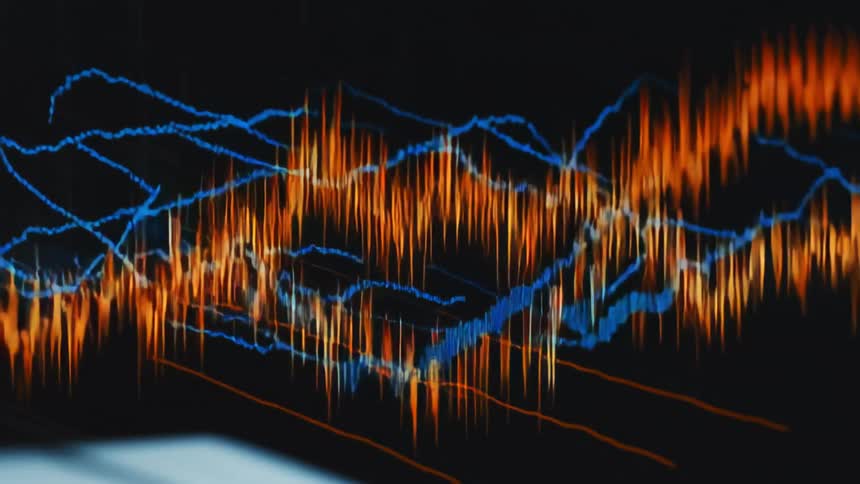 A line graph is on the long monitor