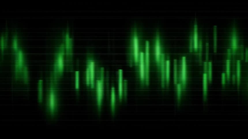 Close up of a blurry device screen displaying a trading interface in green over a dark background