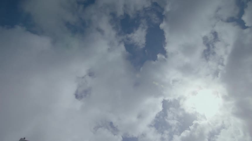 Clouds swirl in a blue sky
