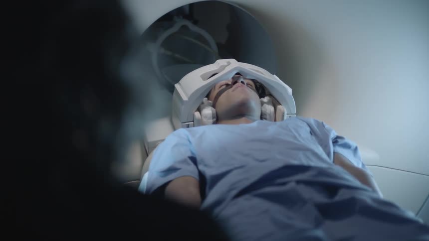 A man lies on a medical machine