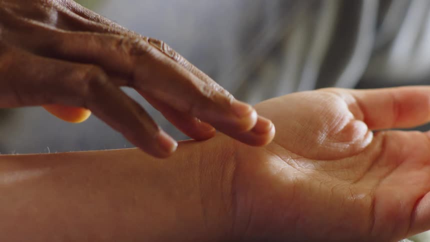 A man is rubbing a womans arm