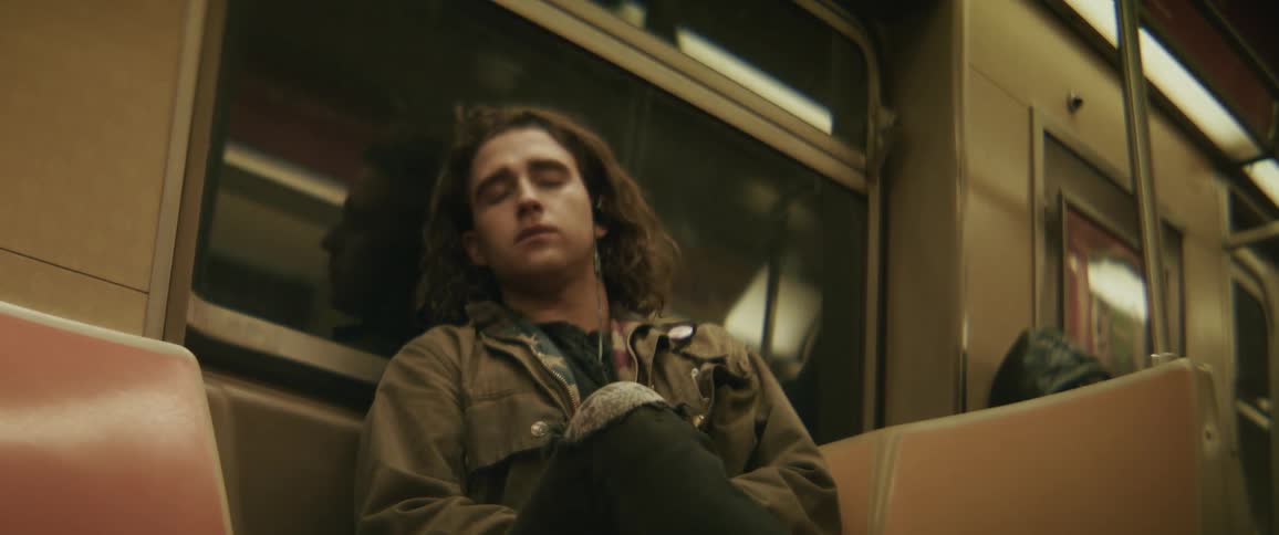Man sitting on a train bench sleeping