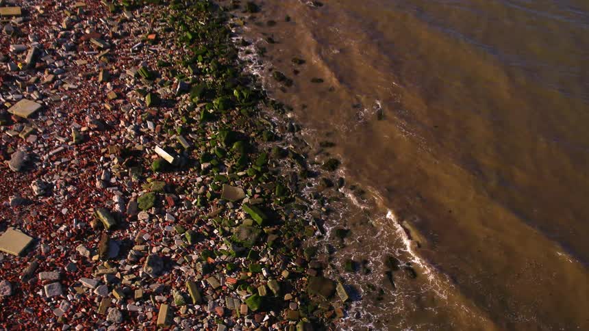 The tide comes ashore on a rocky beach