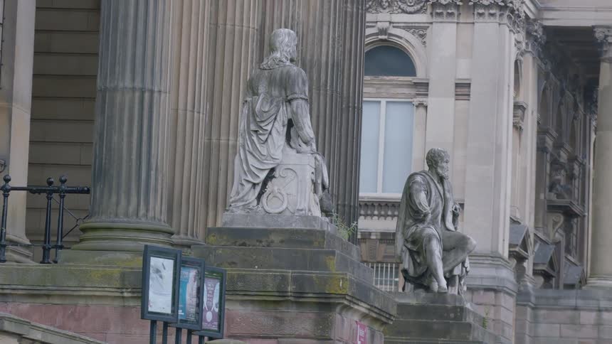 Old statues of men outside a building