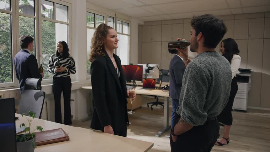 Office workers casually chatting during a relaxed social gathering in a modern workspace