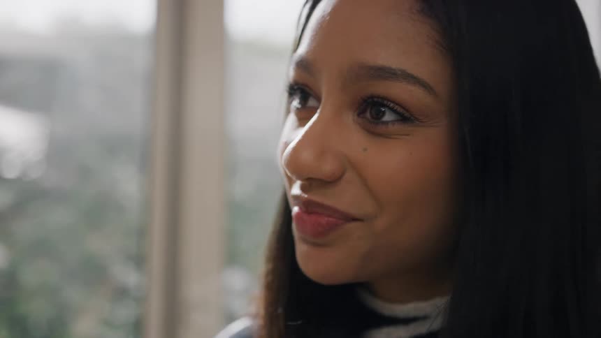A woman is smiling and nodding