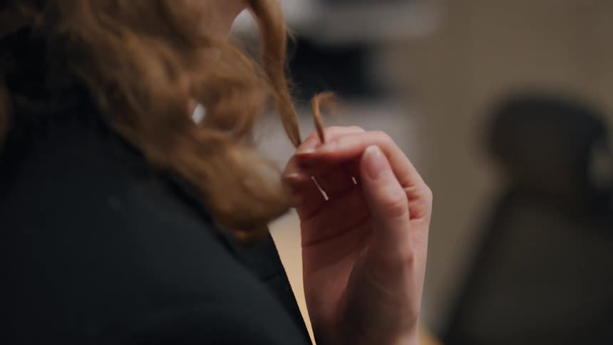 Woman with hand in hair