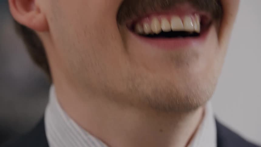 Man smiling midconversation in a closeup office setting