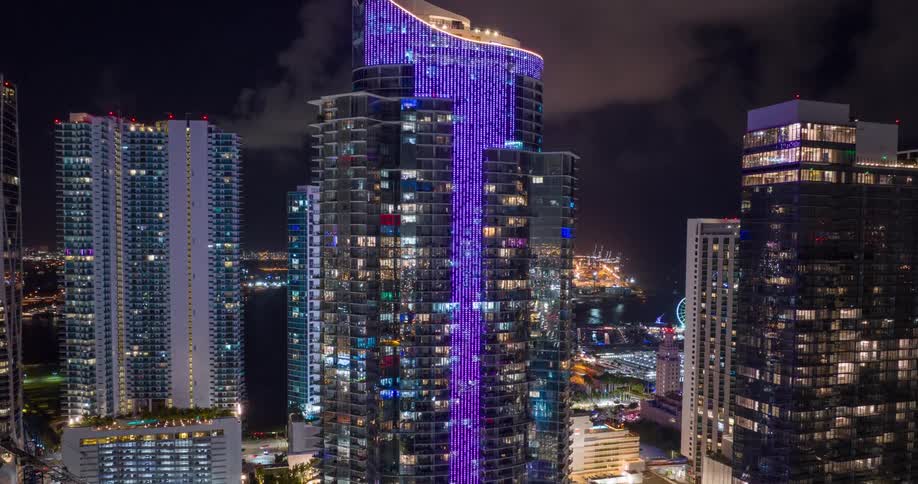 The buildings are colorful with many flashing lights in downtown Miami