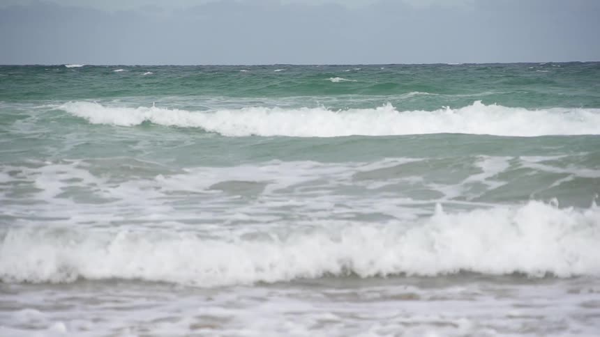 Waves crashing against the beach