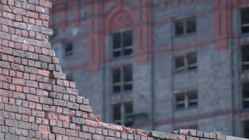 A brick wall partially broken