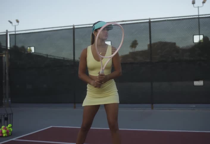 Woman playing a game of tennis on an outdoors court