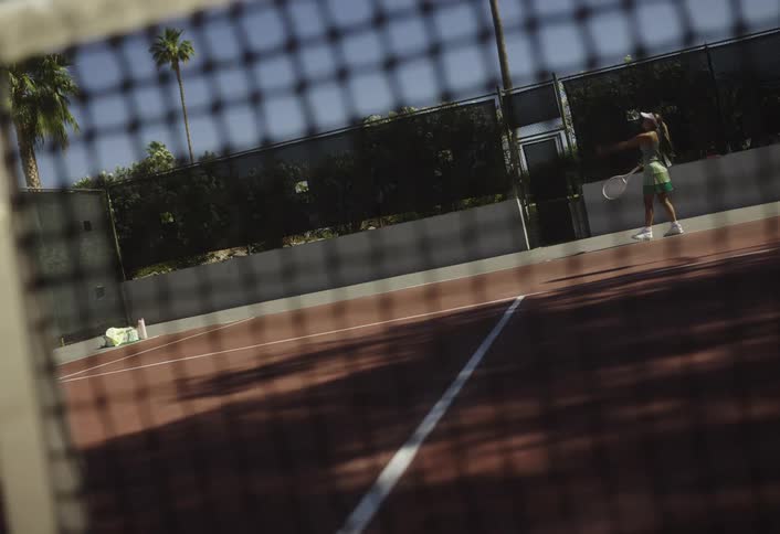 Woman throwing a tennis ball on the court
