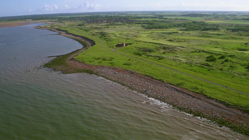 The shore below is surrounded by green