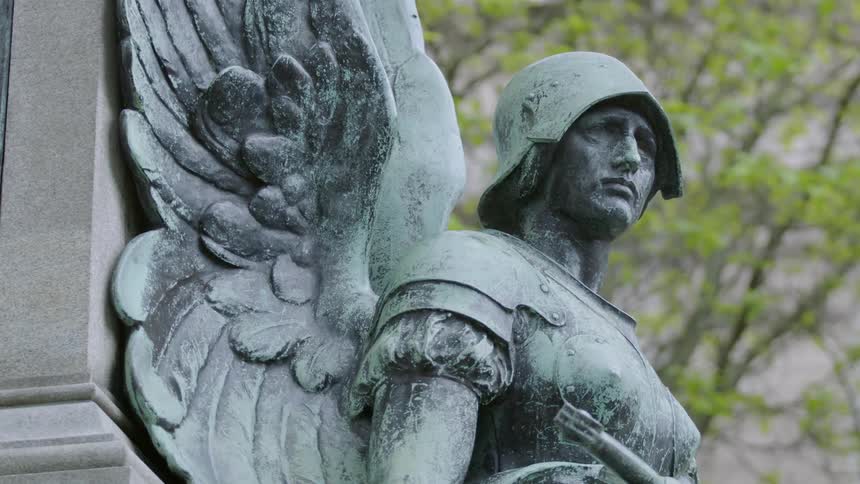 A statue of an angel warrior in a park