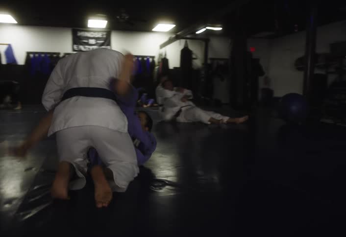 People are practicing mixed martial arts in the gym