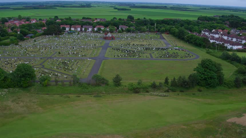 A car travels on a cemetery road