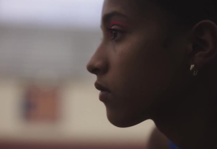 A woman is looking into the distance and wearing makeup