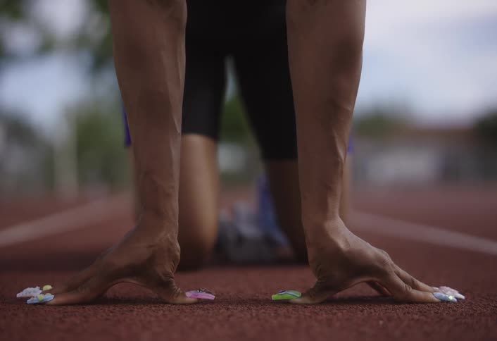 A woman is preparing to run on the track