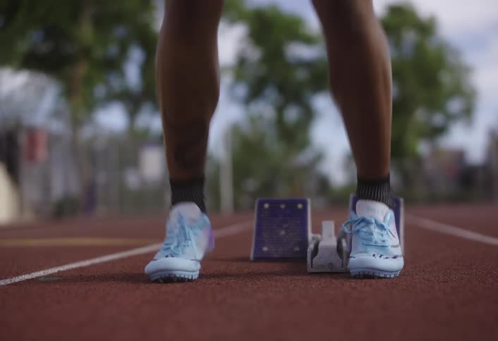 A person jumps up and down on a track