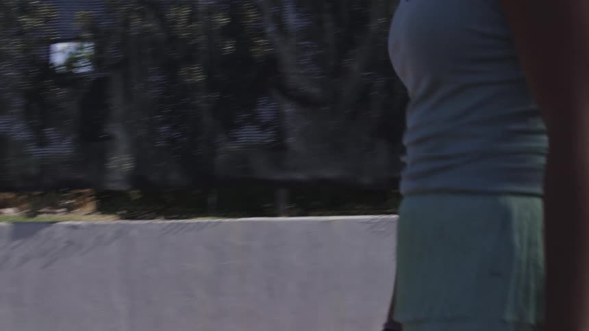 A woman tosses her tennis racket on the court