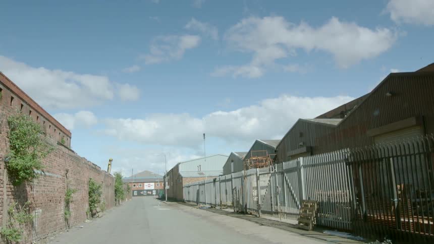 Steel fence lines a city alley