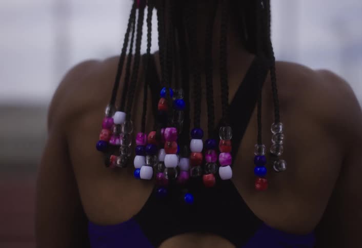 The runner has beads in her hair