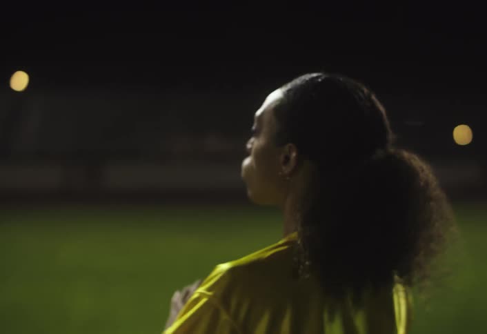 The woman is playing football as the quarterback