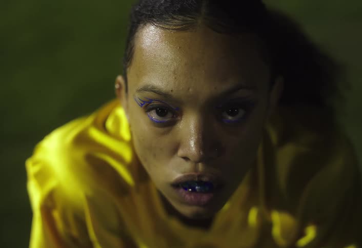 A woman sweats in a yellow outfit