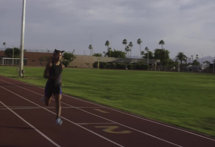 Woman running at high speed on an athletics track