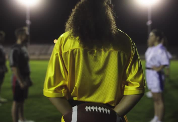 A woman runs to take a place in a v formation on the field