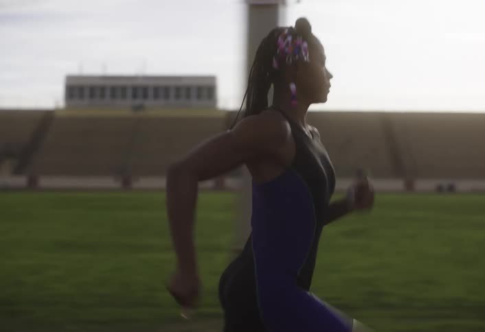 Woman running on an athletics track