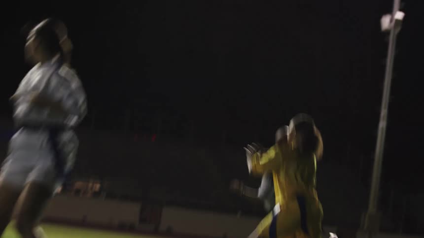 A woman is hiked the ball and she runs with it