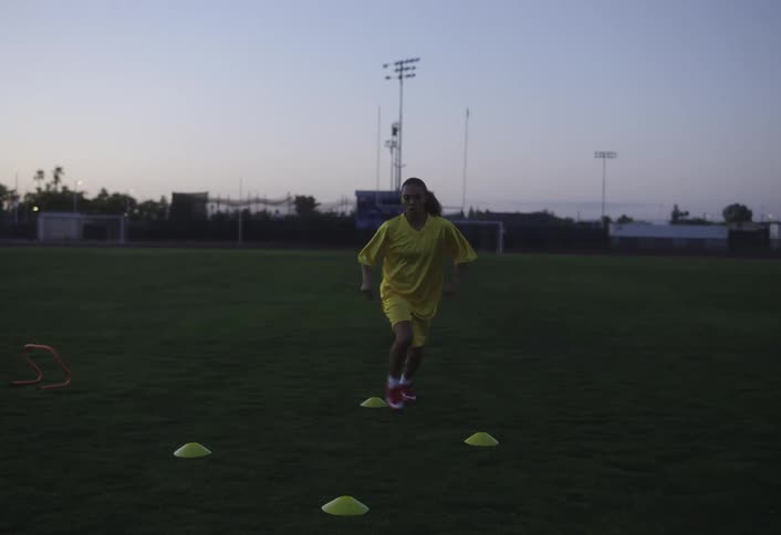 A girl is running and exercising on the field