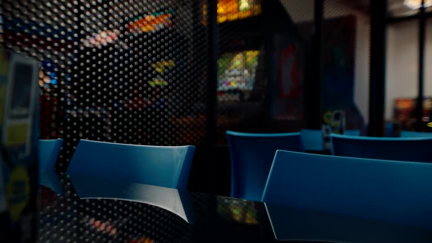 The arcade is empty with many arcade cabinets running