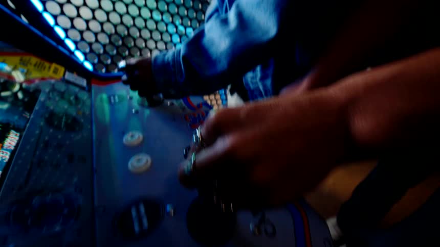 A young happy couple play an arcade game together