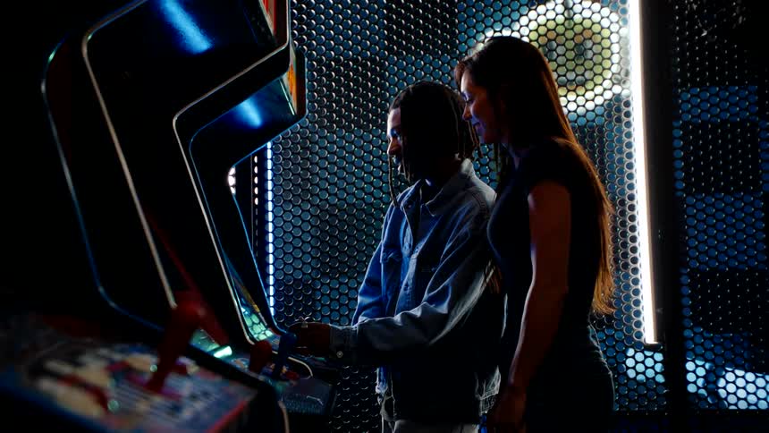 Woman and a man at an old gaming machine
