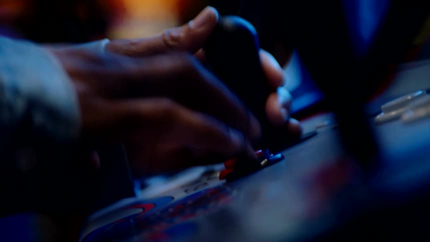 A man plays an arcade game in an arcade store