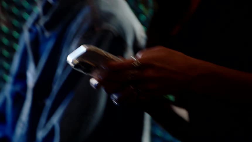 Pair of hands interacting with a smartphone
