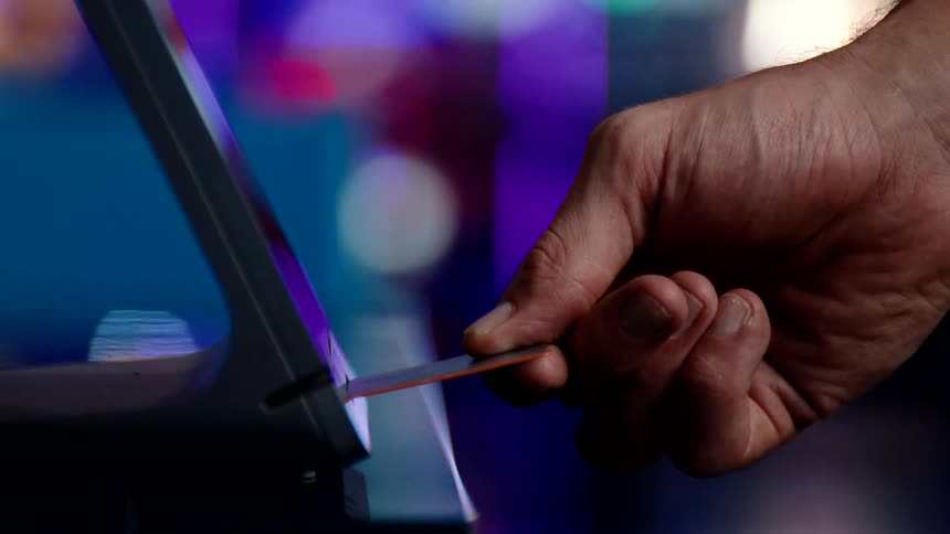 A customer inserts their credit card into the card reader