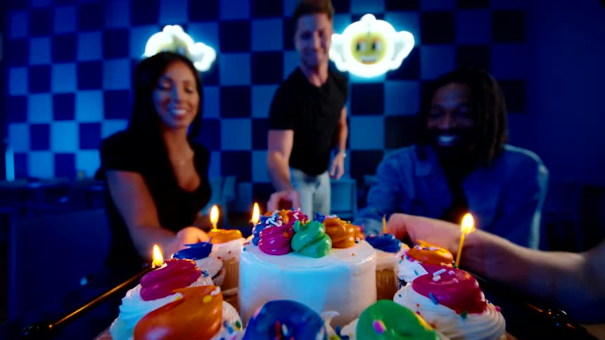 Friends celebrate with cake and ice cream in a festive setting